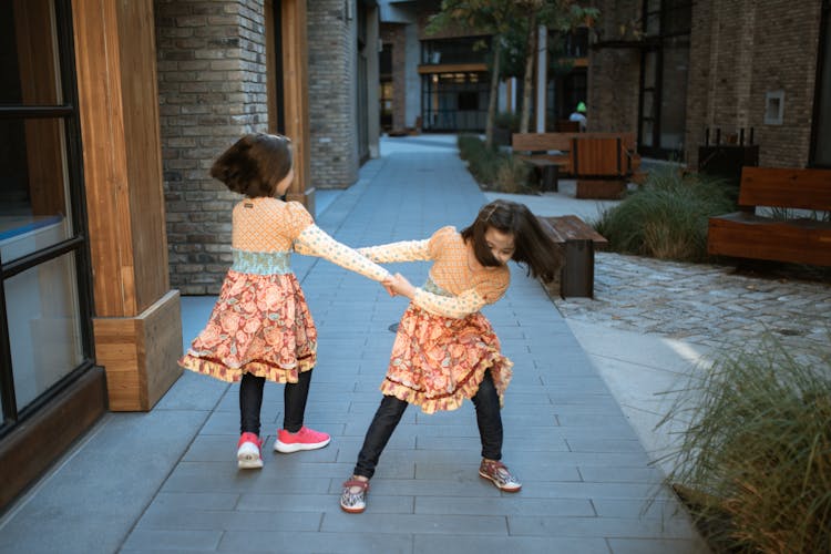 Girls Playing On The Side Of The Street