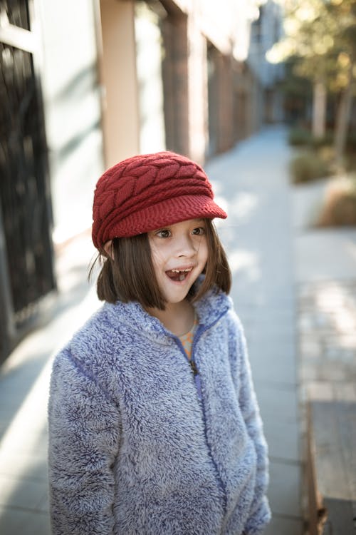 Girl in Blue Jacket and Red Knit Cap