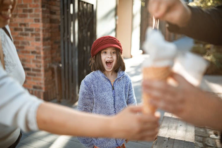 Happy Little Girl Looking Ice Cream Cone