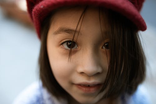 Close Up Photography of Girl in Red Knit Cap