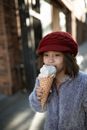 Woman in Blue Coat Holding Ice Cream Cone