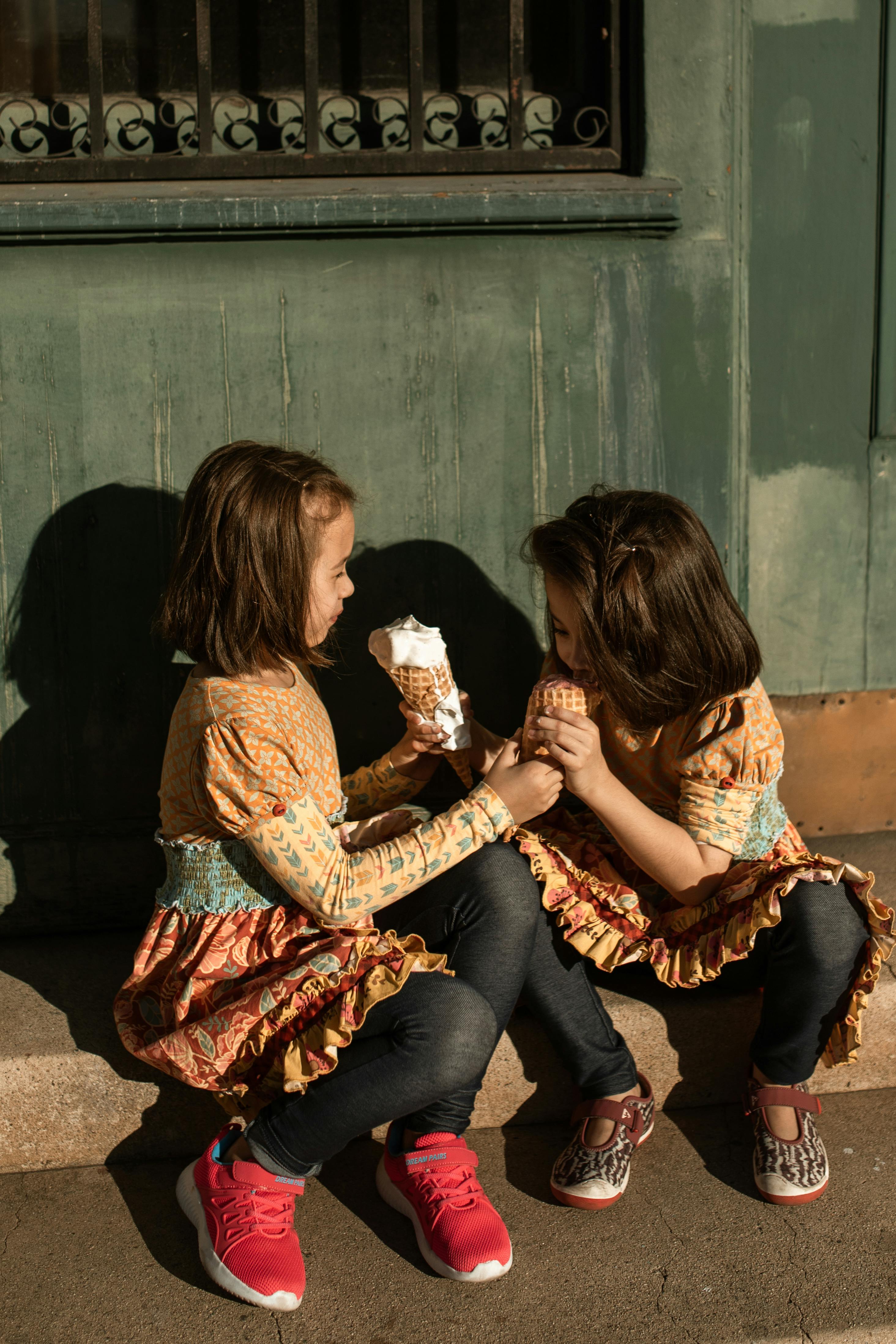 woman in brown long sleeve shirt sitting beside woman in black pants