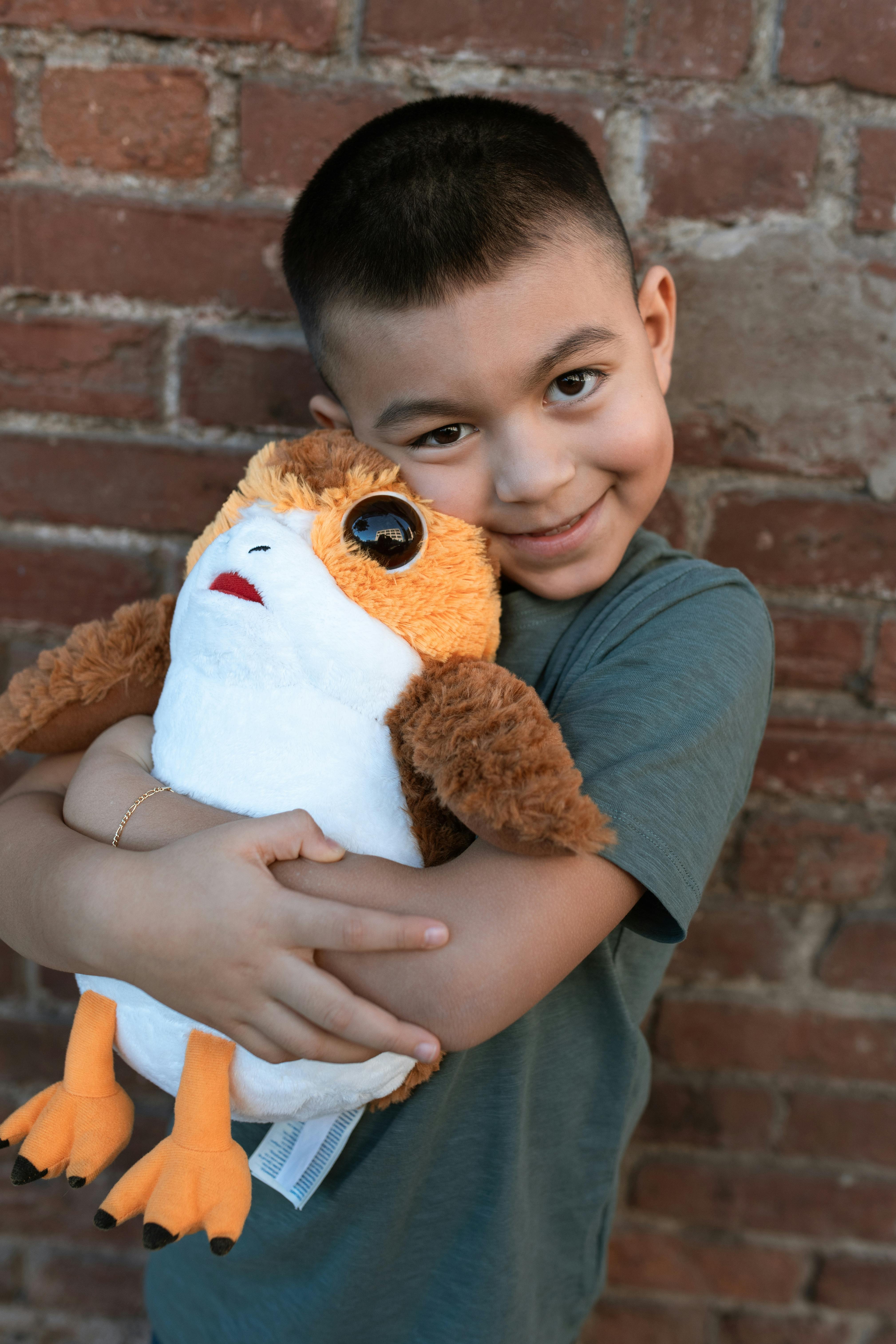 Girl Hugging Stuffed Toy · Free Stock Photo