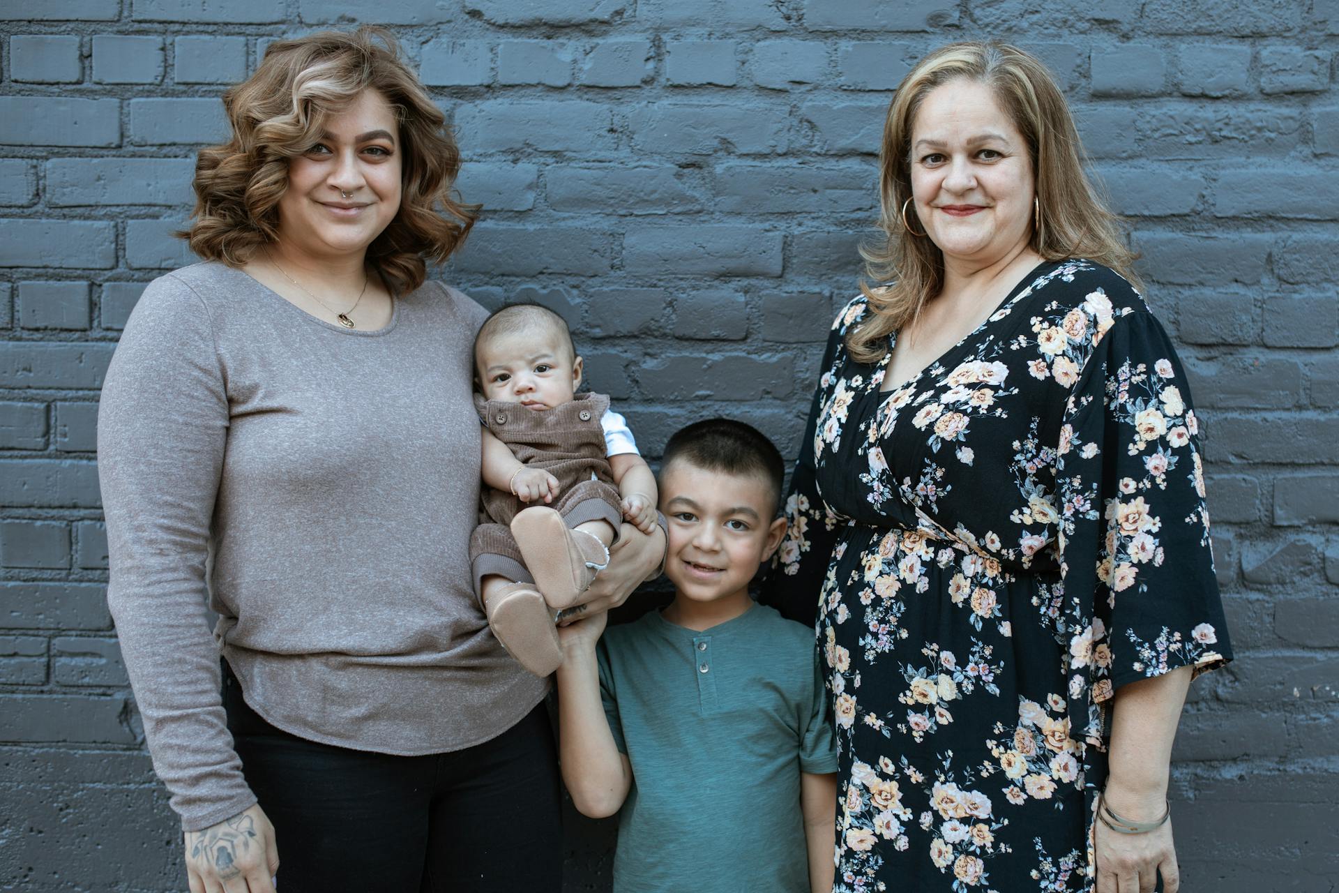 Family portrait with three generations smiling happily together.