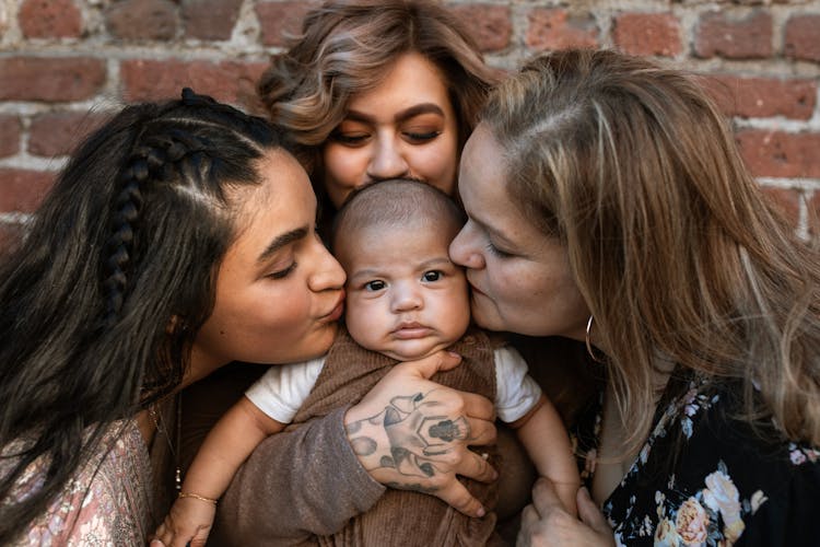 Women Kissing A Baby