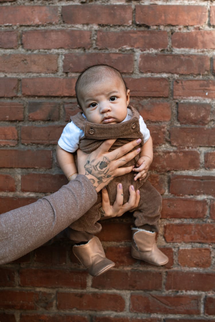 A Person Holding A Baby