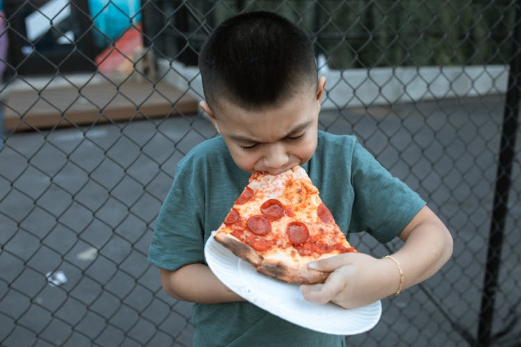 Boy Eating A Pizza