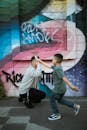 A Boy in Gray Shirt and Denim Pants Giving High Five to a Man