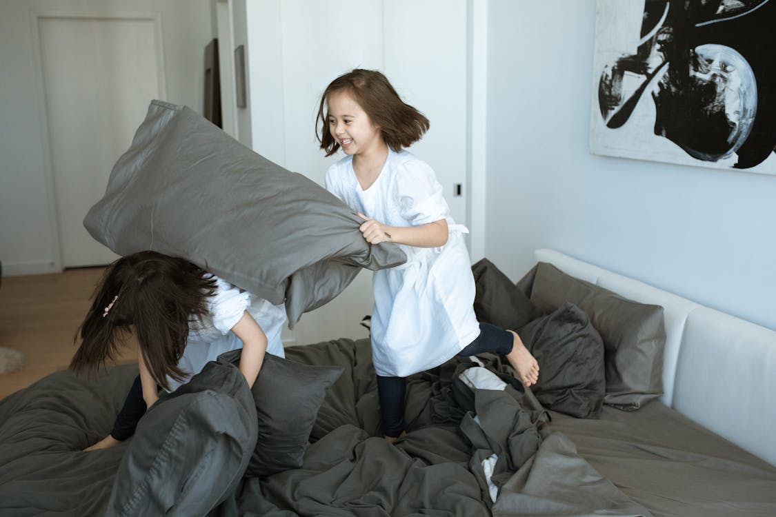 Girls Standing on the bed