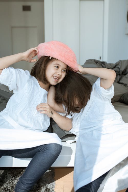 Free Girls in White Shirt Playing with the Hat Stock Photo