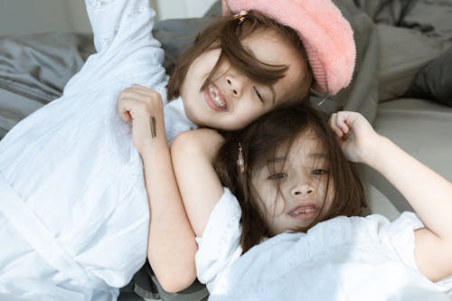 Free Girl in White Shirt Lying on Bed Stock Photo