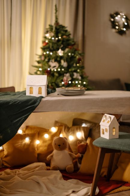 Warm, festive living room with Christmas tree and cozy decorations, perfect for holiday celebrations.