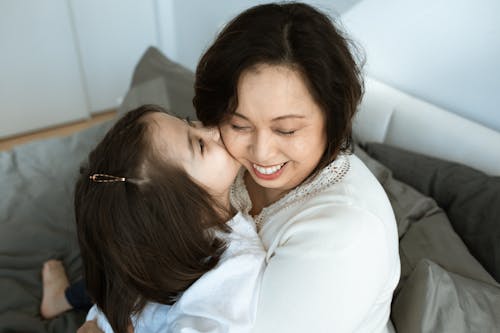 Photo of Girl Kissing a Woman