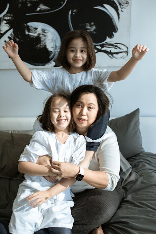 A Woman Posing with Two Girls