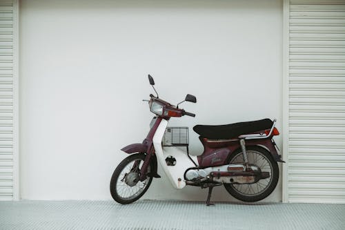 Motorcycle parked near white wall