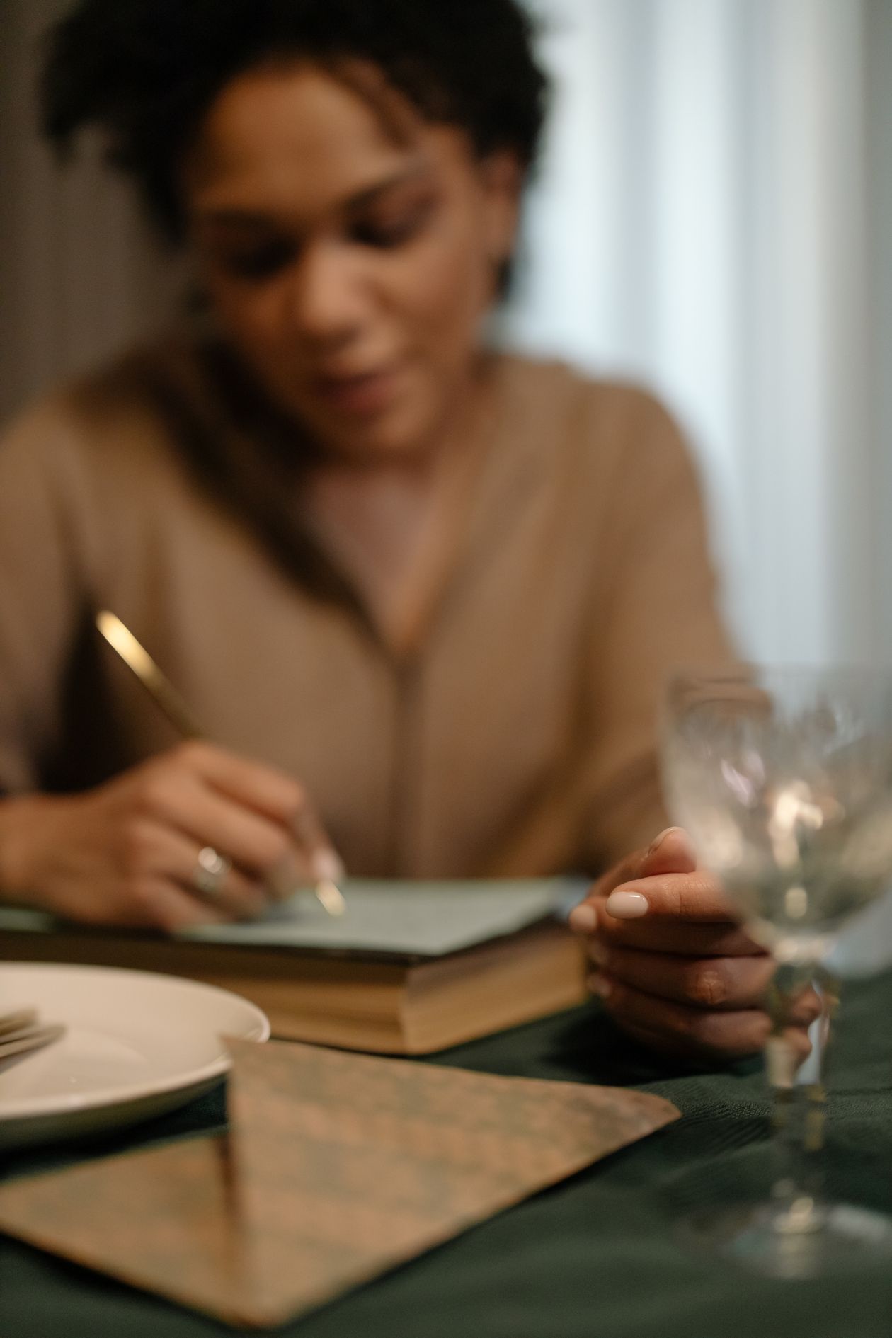 A woman writing in a journal, thoughtful and focused