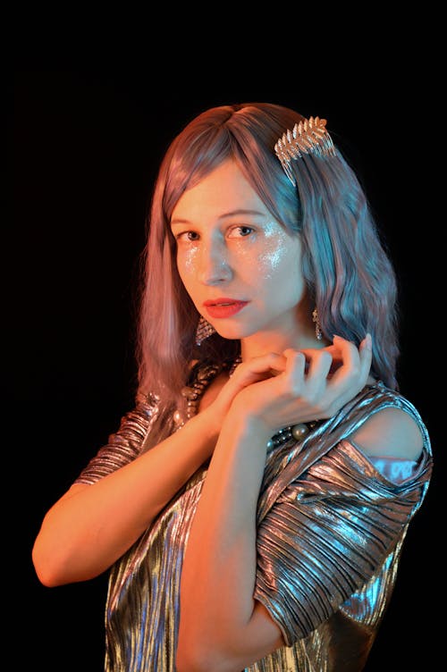 Graceful female millennial looking at camera against black background