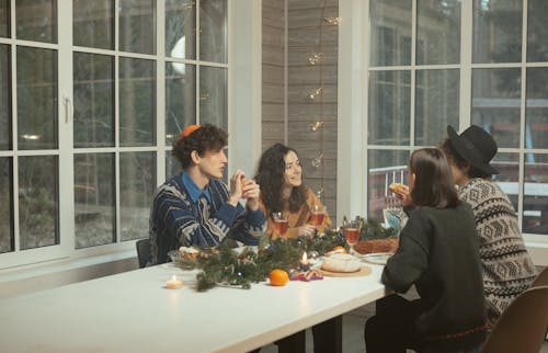 Man in Black Jacket Sitting Beside Woman in Black Jacket