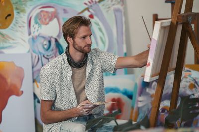 Artist painting on canvas in a studio by Taryn Elliott on Pexels