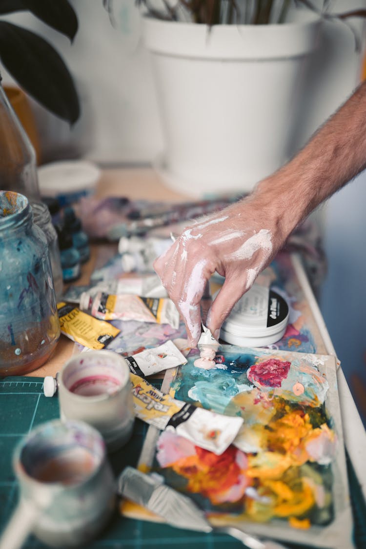 Person Squeezing A Paint Tube