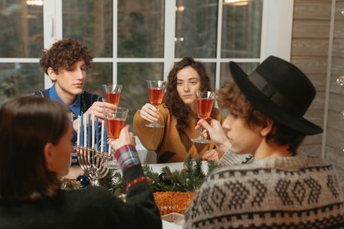 Free Group of friends celebrating with wine glasses indoors. Cozy and festive atmosphere. Stock Photo
