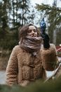Woman Wearing a Fur Coat and a Scarf around Her Neck