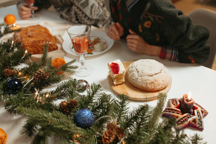 Christmas Decorations And Breads On Dinner Table