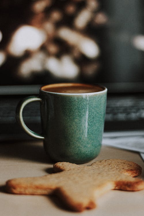 Free Cup of cappuccino on table near sweet ginger cookie Stock Photo