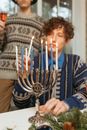 Man Lighting Candles on a Menorah