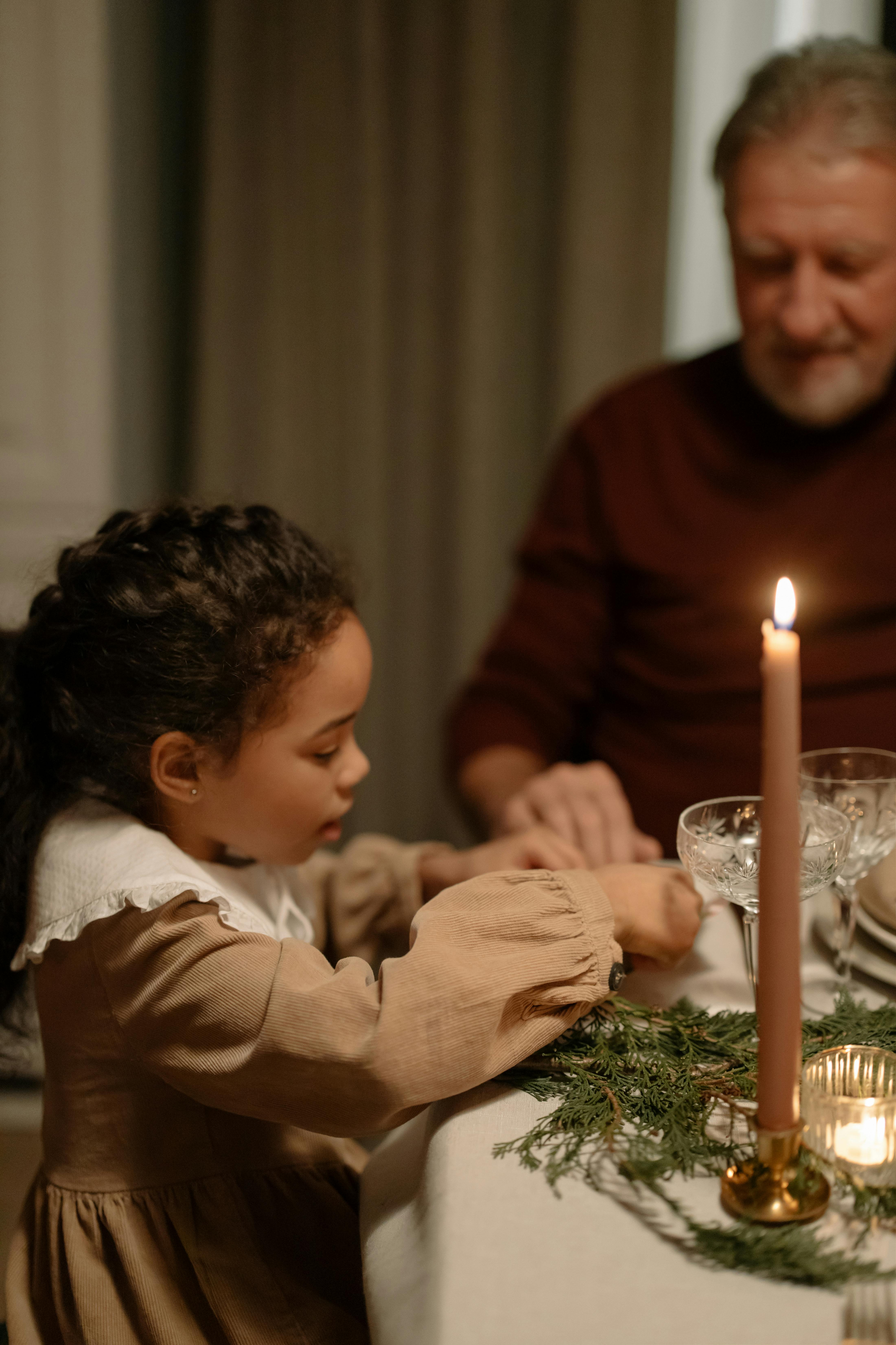 close up shot of a kid at a dining table