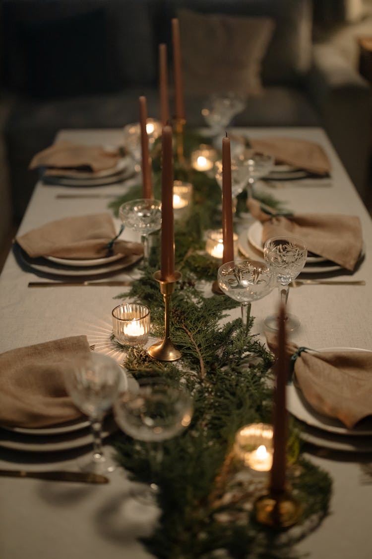 Pine Leaves And Candles On A Dining Table
