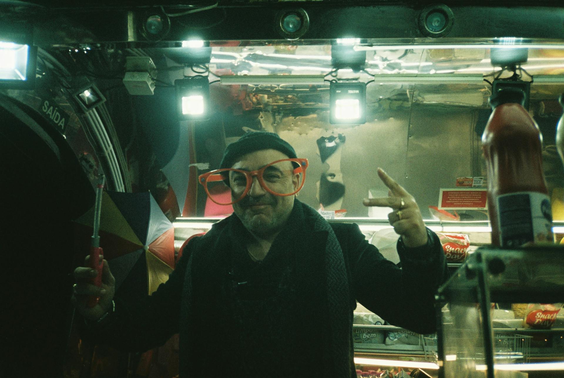 Man Wearing Funny Glasses Standing next to a Street Food Truck