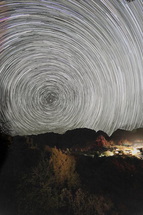 Photo of Star Trails Over a Mountain Landscape