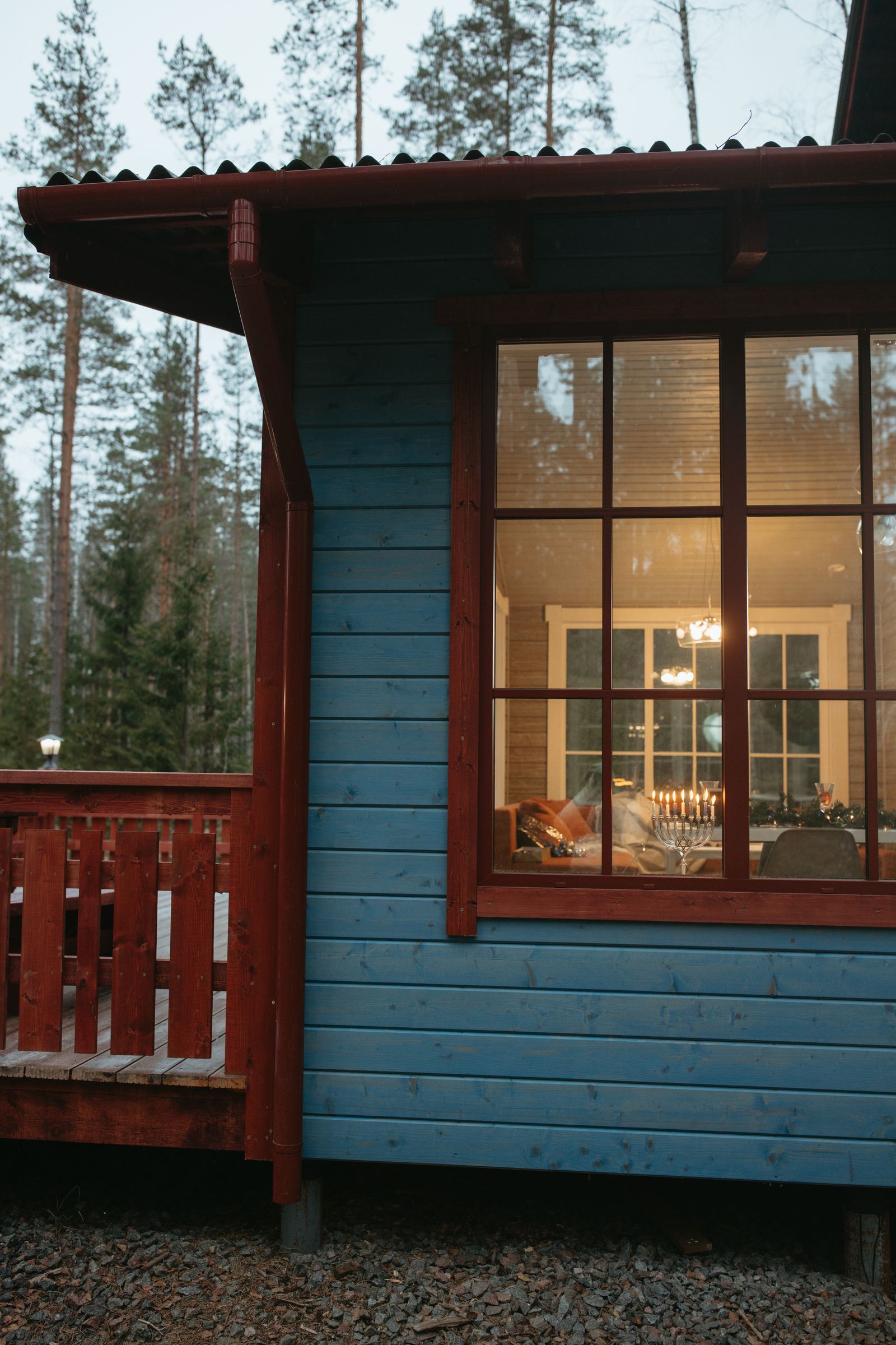 A cabin window surrounded by trees