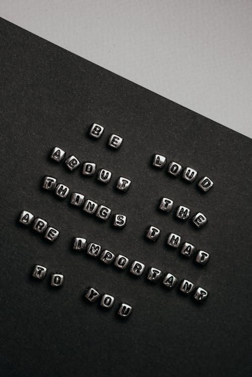 Grayscale Photo of Letter Cubes