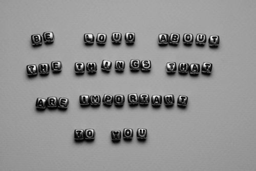 Free Motivational message displayed with alphabet cube beads on a monochrome background. Stock Photo
