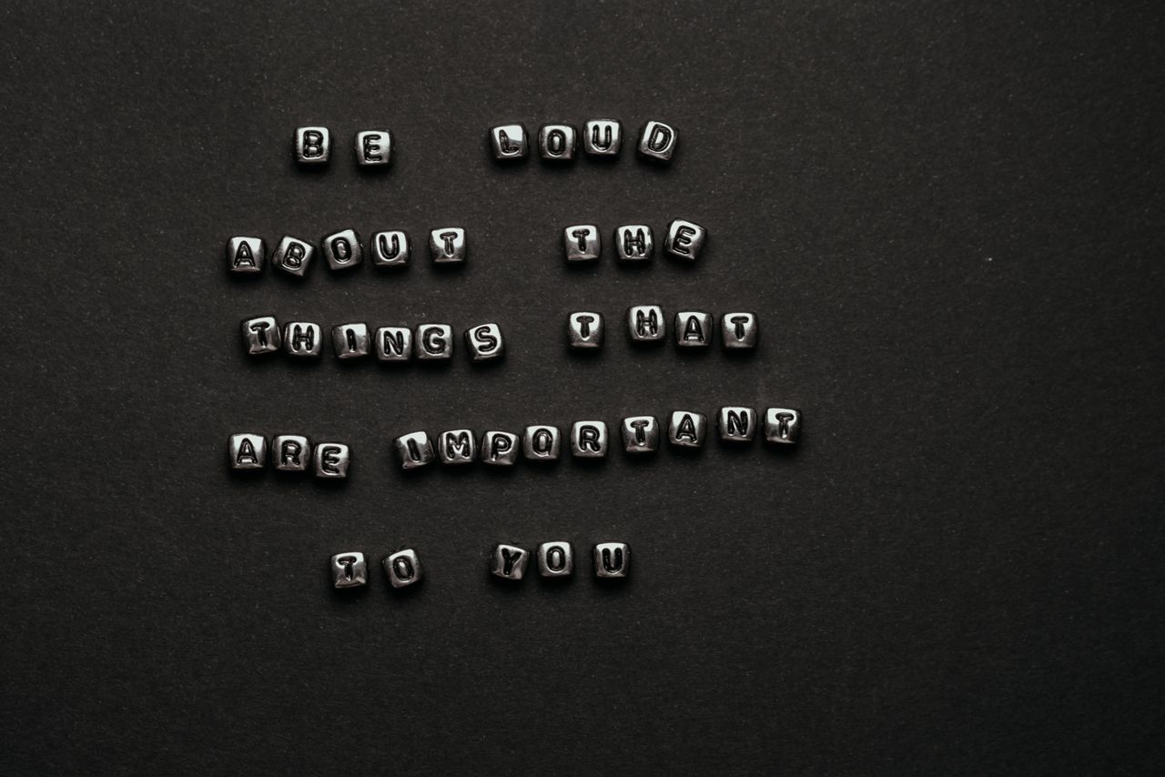 monochrome alphabet cubes form an inspiring quote on a dark background