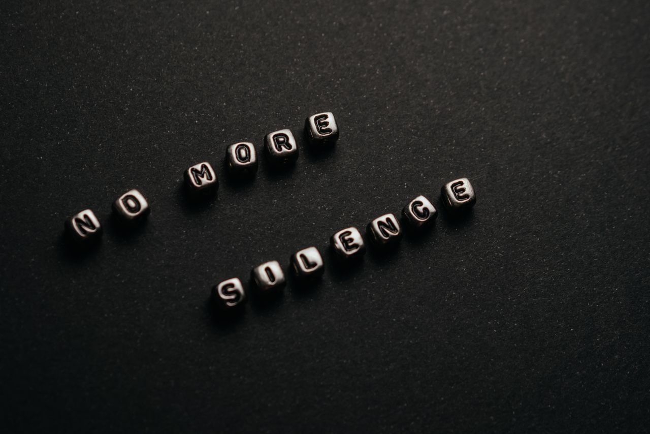 minimalist black and white text art with message no more silence on a