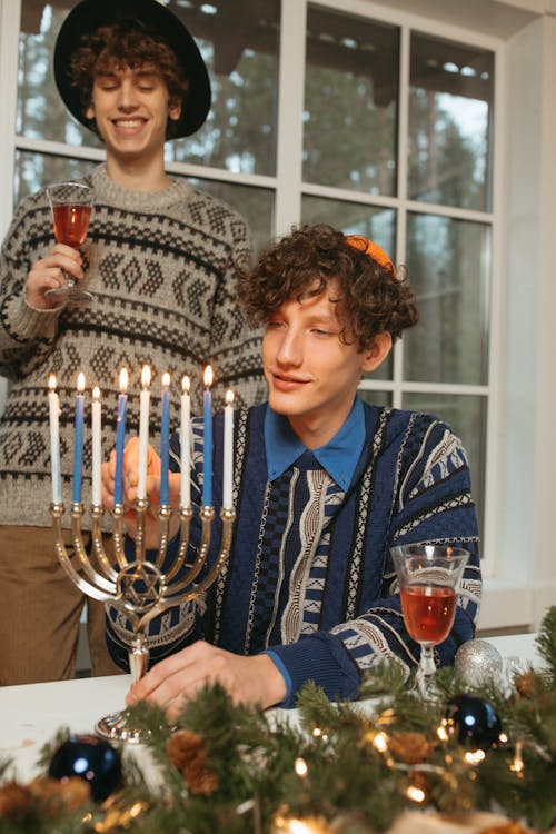 Free Man Wearing a Blue Sweater Holding a Candle Stock Photo