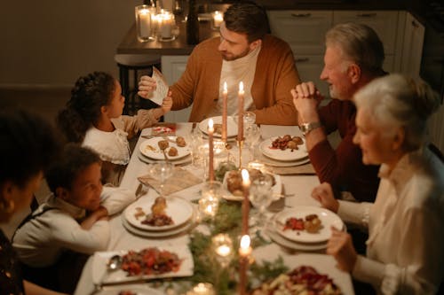 Family Sitting at the Table Having Dinner