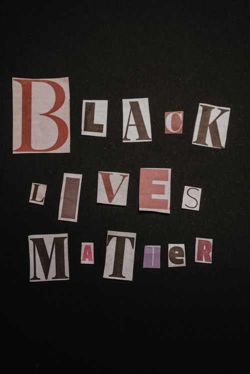 Free A creative composition with cutout letters spelling 'Black Lives Matter' against a black backdrop, symbolizing a social movement. Stock Photo