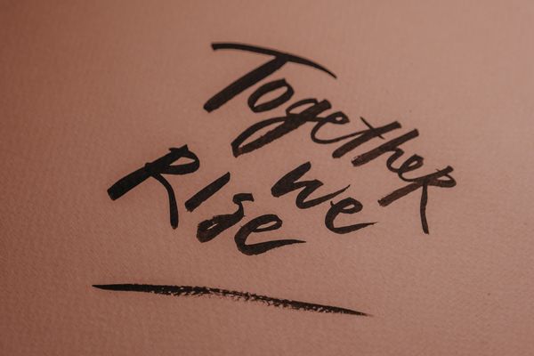 Hand-lettered words on a warm pink ground — photo by Polina on Pexels