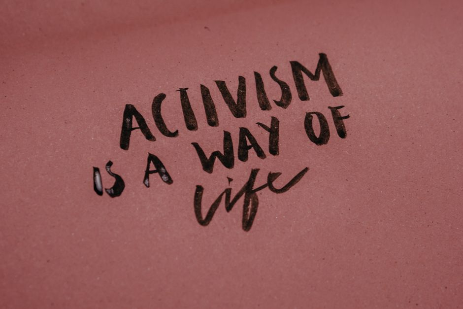 Close-up of a poster with the phrase 'Activism is a way of life' emphasizing social issues.