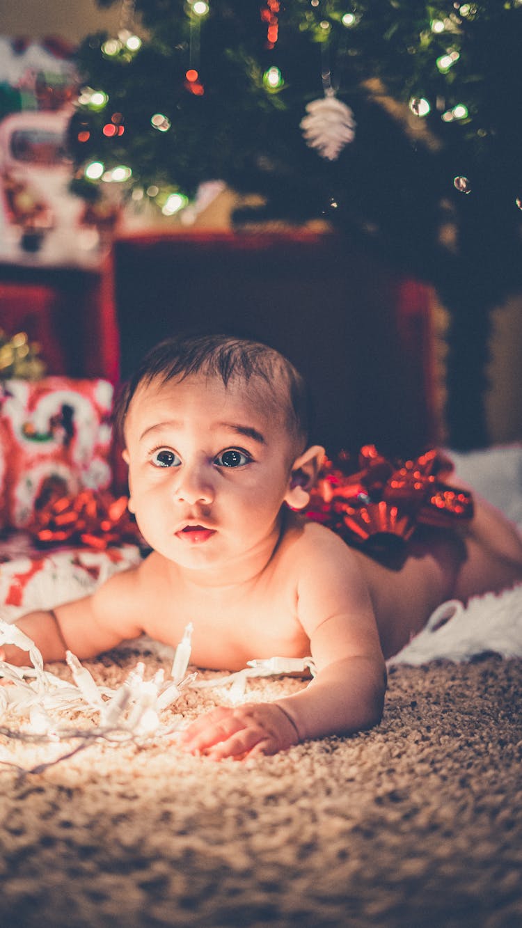 Cute Naked Baby In Room With Christmas Tree