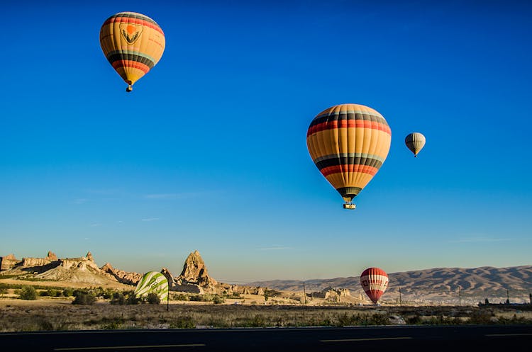 Four Beige Hot Air Balloons Flying