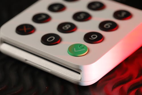 Black and Green Button Numbers on a White Keypad
