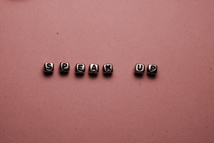 Speak Up Letters On Pink Surface