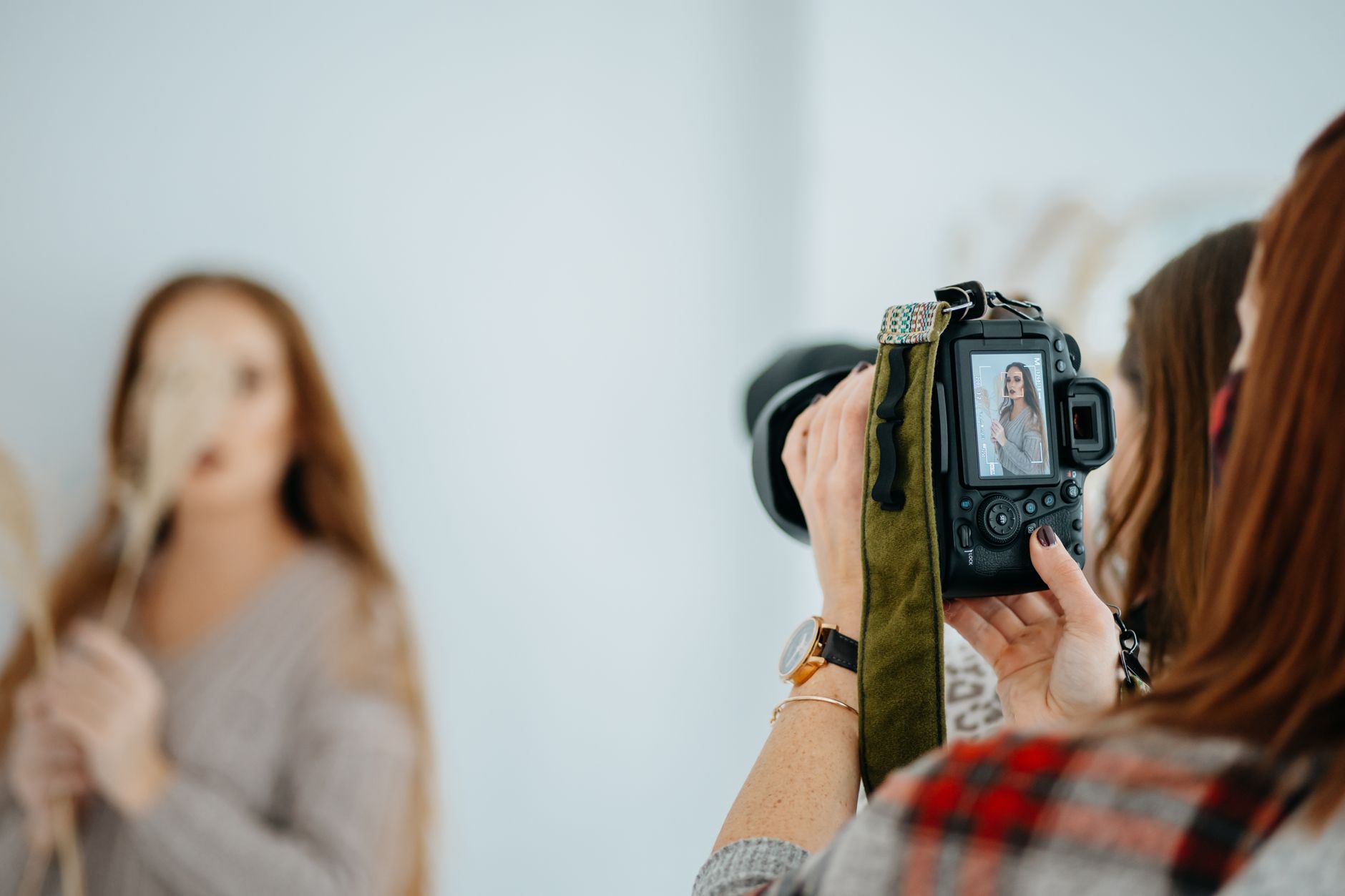 Do You Still Need a Camera When Your Phone Takes Great Photos (phone camera vs camera) image of a photographer with a camera setup in a studio