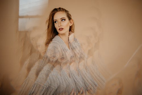 A Woman in a Knitted Sweater Posing