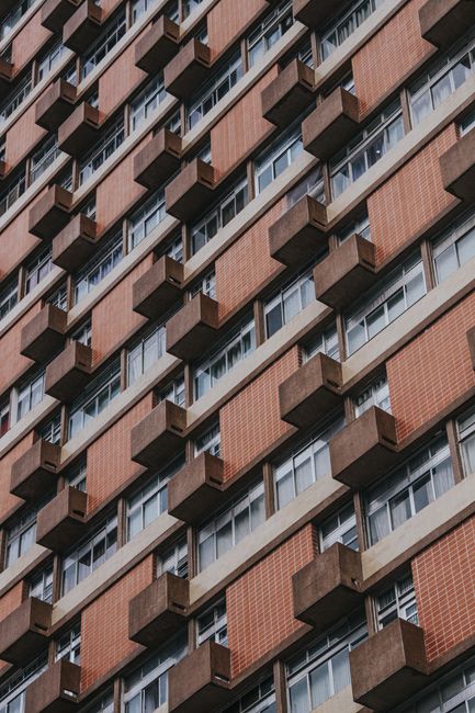 Close-up of a high-rise building with a pattern of windows and balconies.